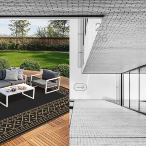 Large black and brown waterproof outdoor rug on a patio deck with modern reversible plastic straw design for RV camping and outdoor living.