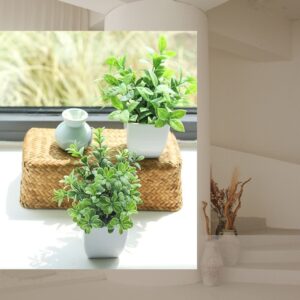 Set of four mini artificial potted greenery plants displayed on a shelf in a modern farmhouse-style home office and bathroom setting.