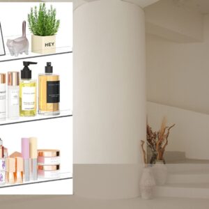 Set of three clear acrylic floating shelves mounted on a wall displaying books, perfumes, makeup, plants, and decorative accessories in a modern home.