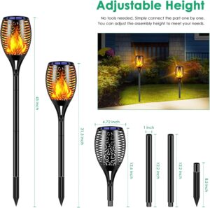 Tall waterproof solar torch lights with realistic flickering flame LEDs illuminating a garden pathway at night.
